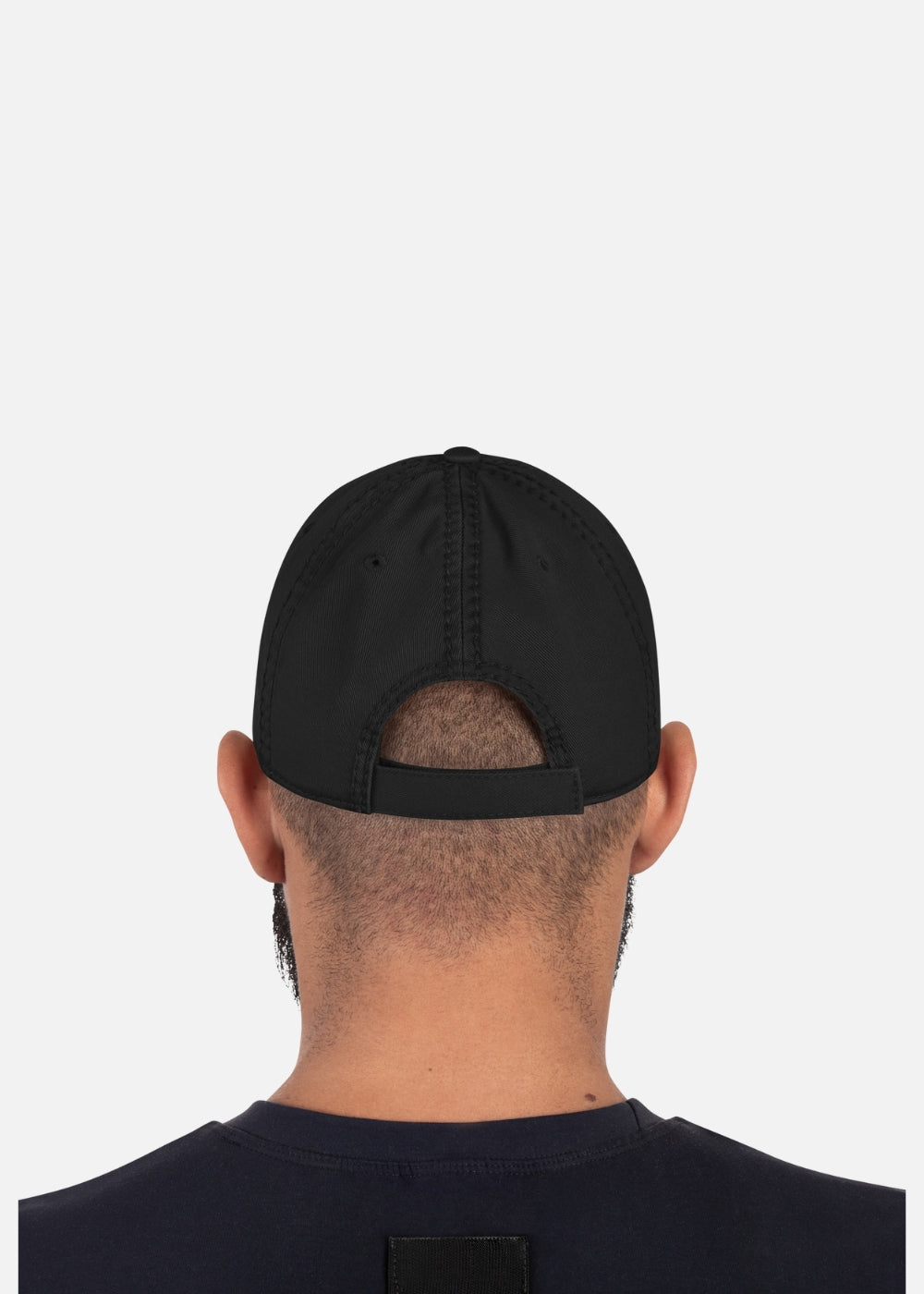Back view of male model with adjustable black streetwear cap – unstructured and urban-ready for every bold look.
