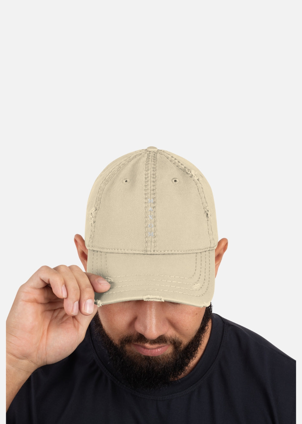 Male model wearing khaki distressed urban cap – vintage 90s streetwear look with breathable design and adjustable closure.