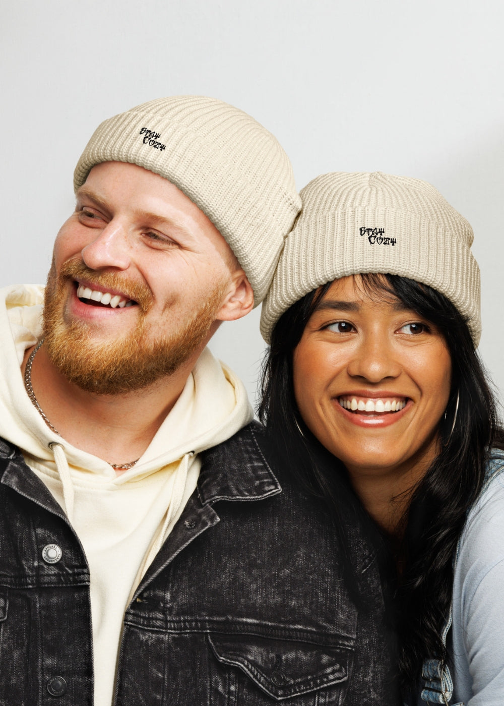 Unisex couple wearing beige MAXOMclo beanies – trendy urban knit hats for cold-weather streetwear