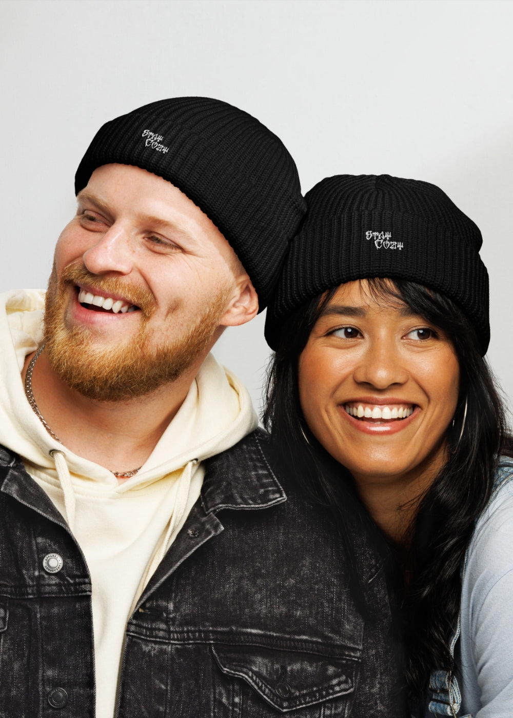 Couple wearing black MAXOMclo streetwear beanies – unisex winter knit hats with bold urban style