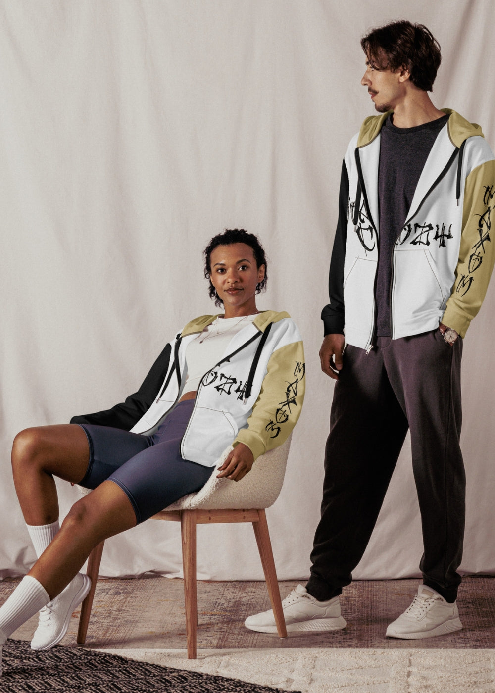Unisex models in real life wearing Stay Cozy zip hoodies β sustainable couple streetwear outfit with urban vibe