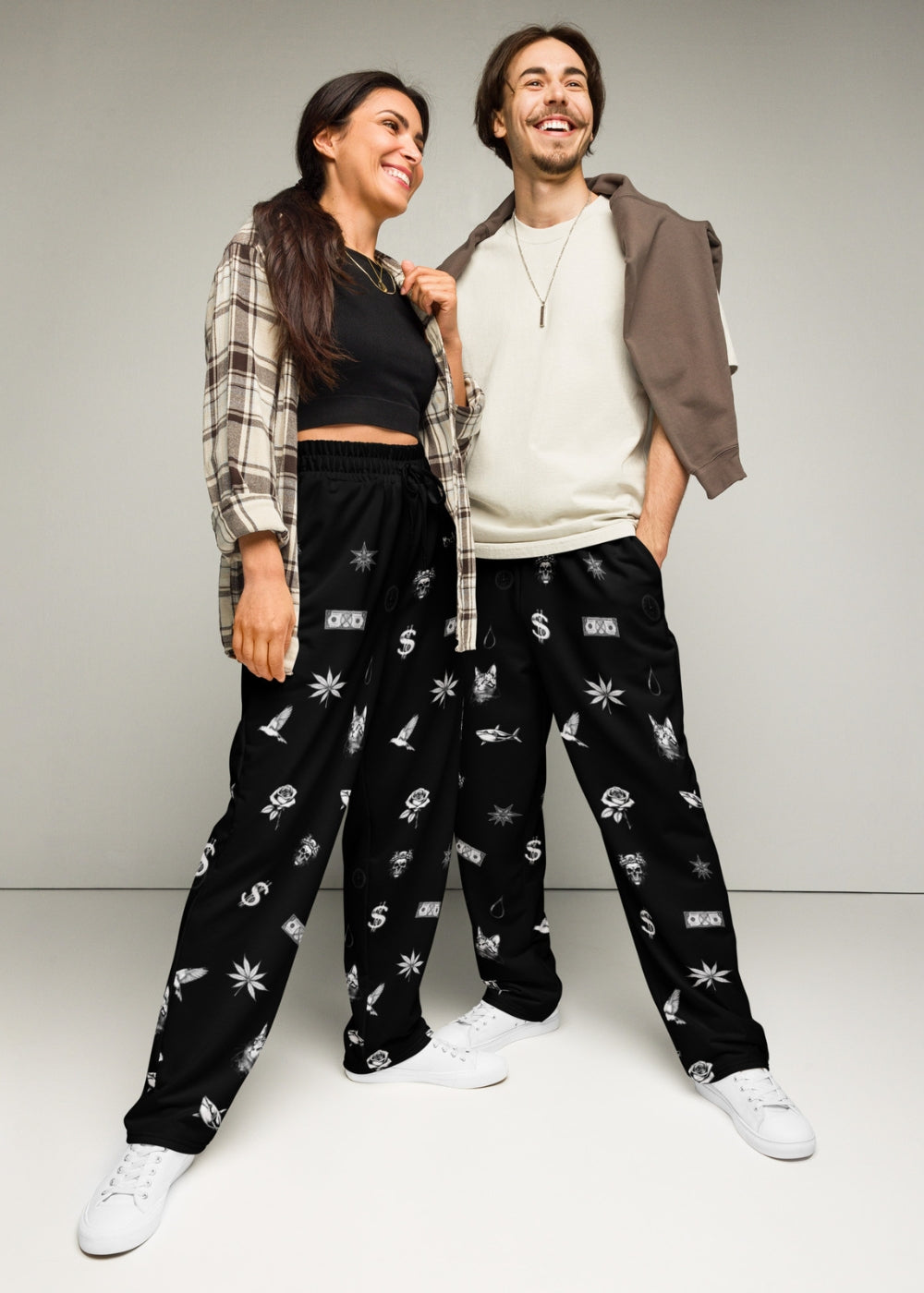 Streetwear couple look – man and woman wearing matching sweatpants for coordinated urban outfits.