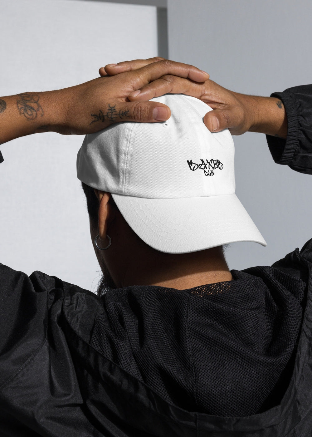White chino cotton twill low-profile cap worn by male model – premium streetwear accessory for casual everyday style.