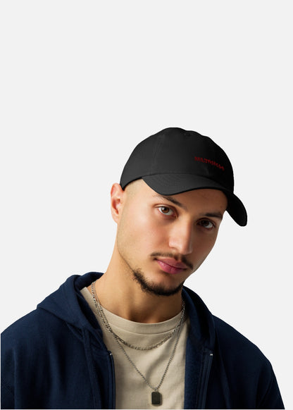 Urban male model with black moisture-wicking baseball cap – perfect for active streetwear fashion.