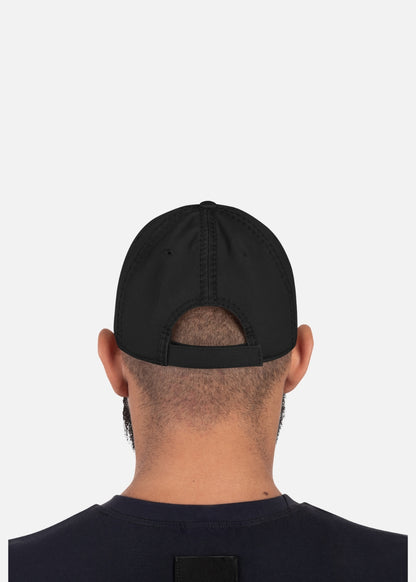 Back view of male model with adjustable black streetwear cap – unstructured and urban-ready for every bold look.

