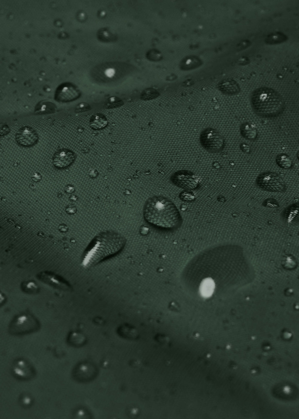 Green waterproof jacket close-up showing rain resistance – eco-friendly streetwear outerwear