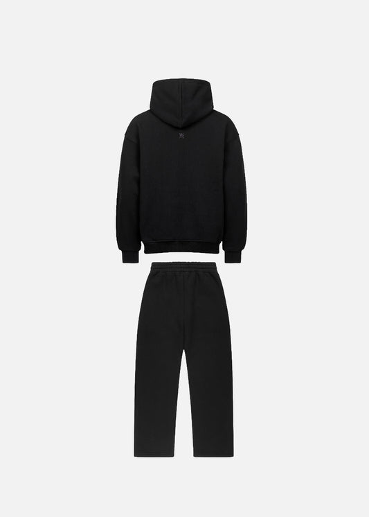 Back view of MAXOMclo Purple Obsidian urban fashion tracksuit set in all-black with purple lettering. Premium oversized hoodie and sweatpants for a bold streetwear look.