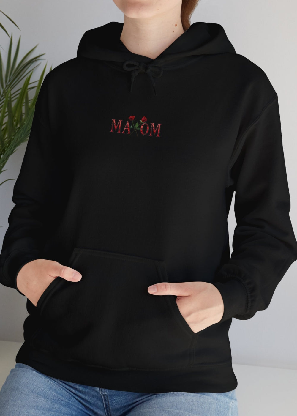Real life female model in black rose hoodie – urban floral streetwear with inspirational vibe