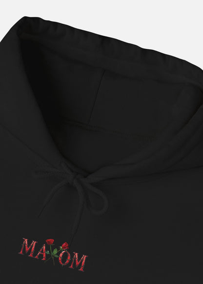 Detailed view of MAXOMclo black hoodie with inspirational quote and rose illustration on the back