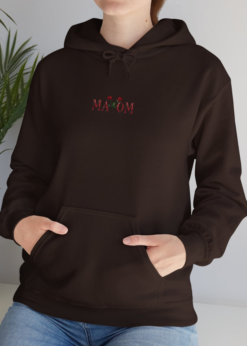 Lifestyle shot of female model in brown rose hoodie – cozy unisex streetwear for everyday positivity